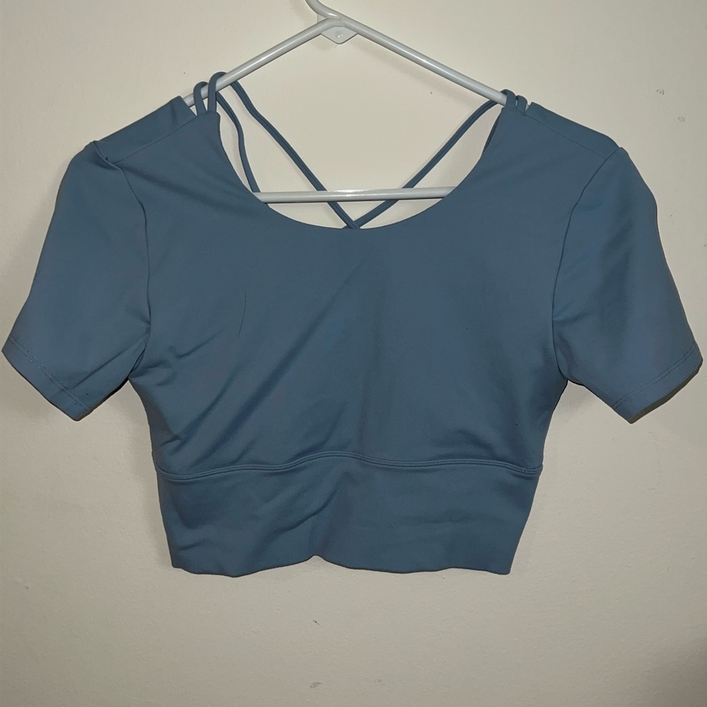 Round neck short sleeve backless crisscrossed cropped sports top. Glacier blue.
